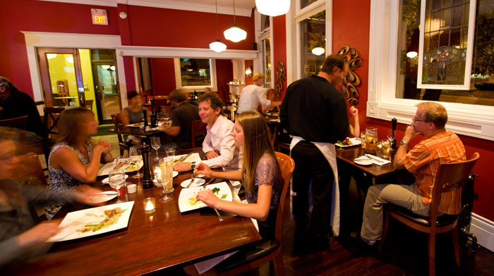 A waiter taking an order at Brownstone Restaurant.