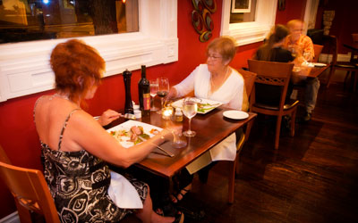 Two women enjoying dinner at Brownstone Restaurant.